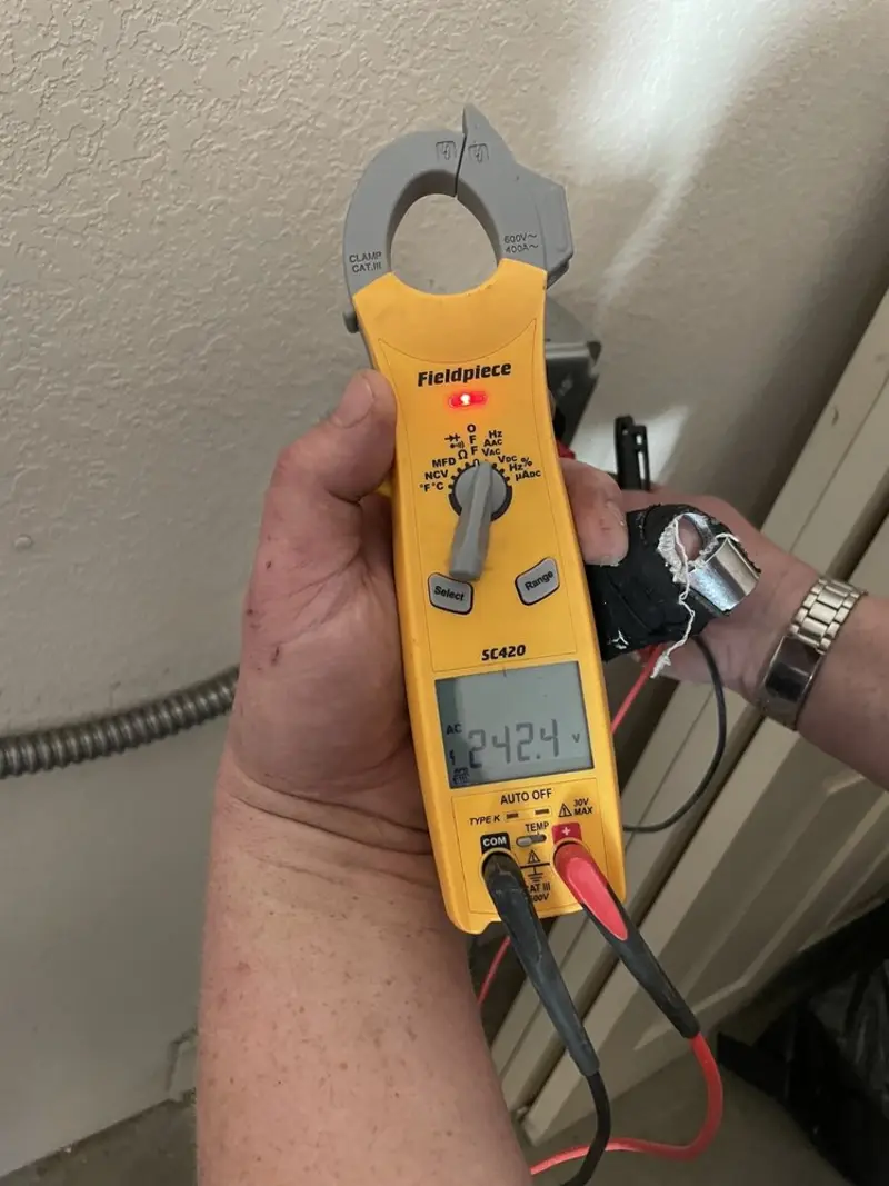 Voltage testing with clamp meter during Ceiling Fan Installation in Alpena